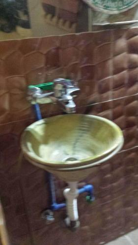 a bathroom sink with a faucet on a wall at GITE Take your time in Merzouga