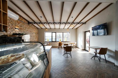 a room with a bakery with tables and chairs at 281 Hostel in Bishkek