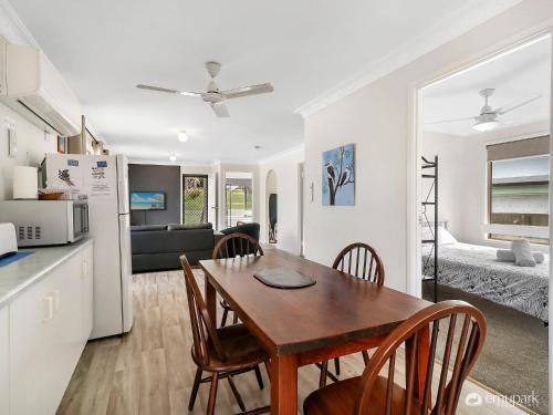 a kitchen and dining room with a table and chairs at Sea Breeze On Archer! in Emu Park