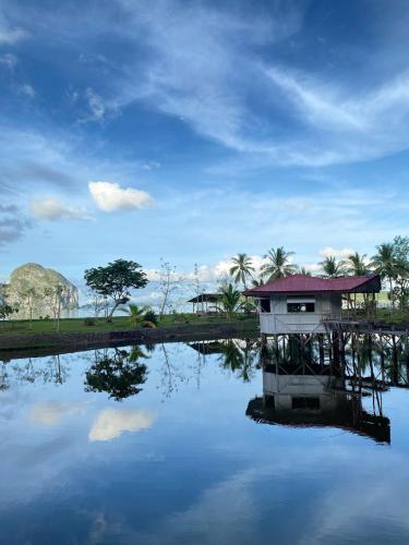 a house in the middle of a body of water at CED Farm in El Nido