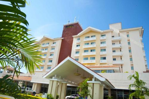 a large white building with a red tower at Radisson Colon 2,000 Hotel & Casino in Colón
