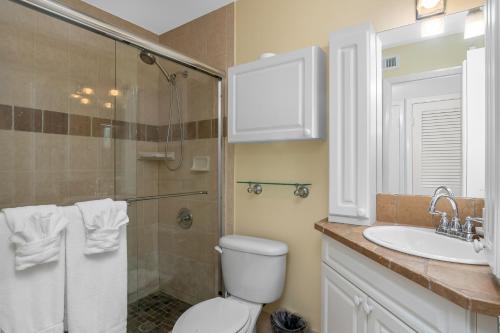 a bathroom with a toilet and a sink and a shower at Hidden Gem 813 in Naples