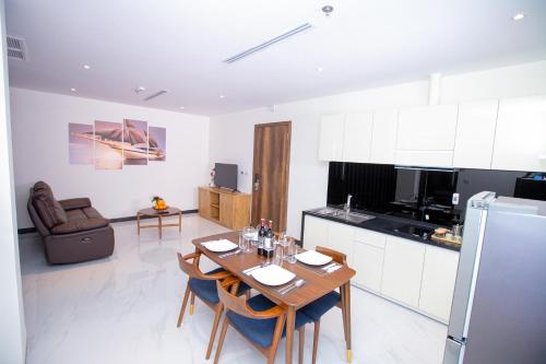 a kitchen with a table and chairs in a room at Sea Breeze Hotel & Villa in Sihanoukville