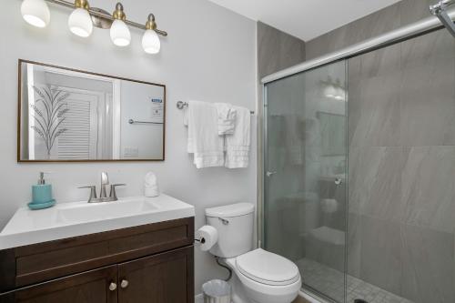 a bathroom with a shower and a toilet and a sink at Sandy Waves 817 in Naples