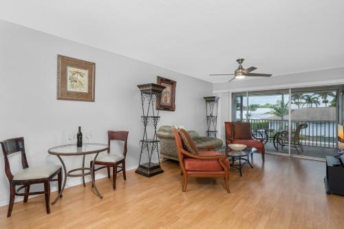 a living room with a table and chairs at Sandy Waves 817 in Naples