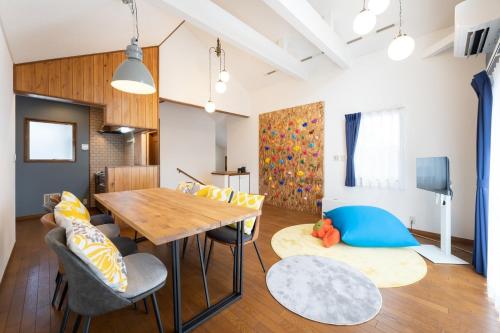 a living room with a wooden table and chairs at s-villa Nasu-hillside in Nasu
