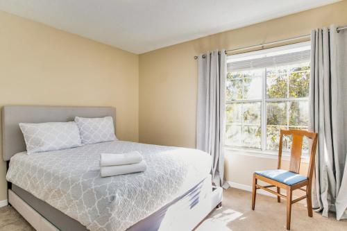 a bedroom with a bed and a window and a chair at Bayside Manor near Airport & Beaches in Pensacola