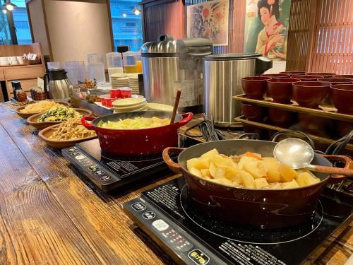 a buffet with various dishes of food on a table at Kusatsu Daiichi Hotel in Kusatsu