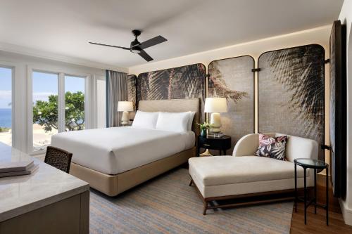 a hotel room with a bed and a chair at The Villas at Fairmont Kea Lani in Wailea