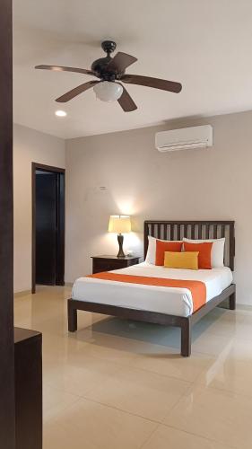 a bedroom with a bed with a ceiling fan at Casa Valladolid Boutique Hotel in Valladolid