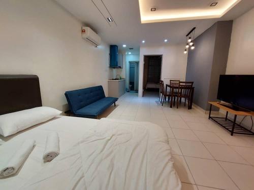 a hotel room with a bed and a living room at Rest And Go Homestay in Shah Alam