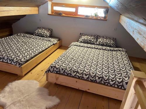 a bedroom with two beds and a rug at Holiday home in Drganja sela Kranjska Krain 42002 in Drganja Sela