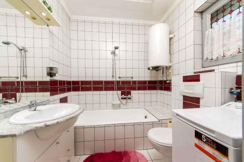 a bathroom with a tub and a sink and a toilet at House and Apt in Balatonboglar 42692 in Balatonboglár