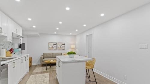 a kitchen with white cabinets and a counter top at Family Friendly - Cozy - HOT TUB - Near UOIT in Oshawa