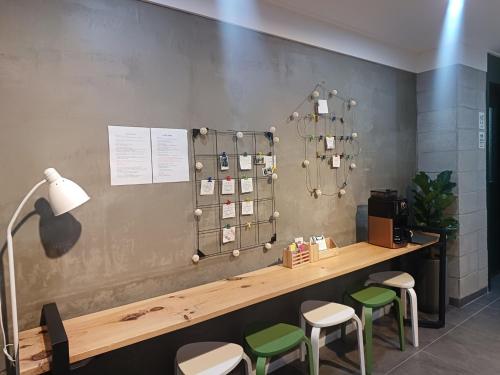 a room with a counter with stools and a table at Aha Stay in Gyeongju