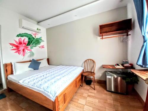 a bedroom with a bed with a desk and a chair at Sông Suối Homestay in Quy Nhon