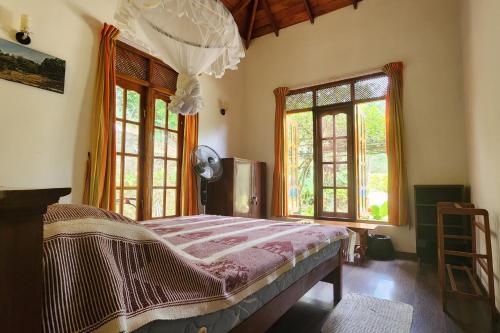 a bedroom with a bed in a room with windows at SunnySide Lodge - Tea Plantation Bungalow in Ella