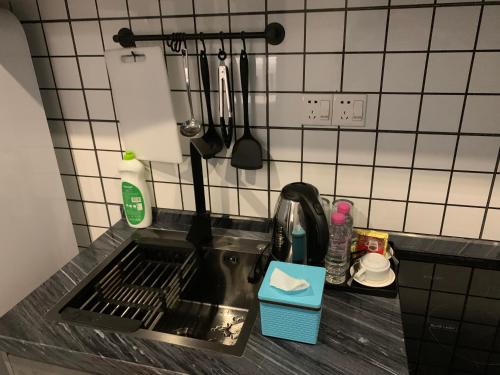 a kitchen counter with a sink and utensils at 21B No.1 Best Location In Phnom Penh Capital, Swimming Pool & Gyms in Phnom Penh