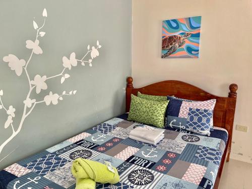 a bedroom with a bed with a quilt on it at D' Partner's Inn in Jagna