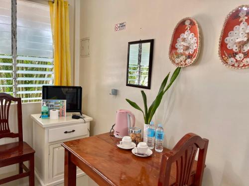 a dining room with a table and a tv at D' Partner's Inn in Jagna