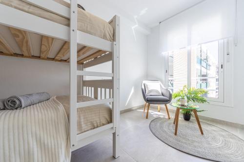 A bed or beds in a room at BOOOOM Apartment Salou Beach