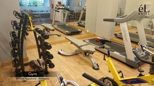 a gym with a bunch of exercise equipment on the floor at eL Hotel Yogyakarta Malioboro in Yogyakarta