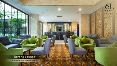 a lobby of a hotel with chairs and tables at eL Hotel Yogyakarta Malioboro in Yogyakarta