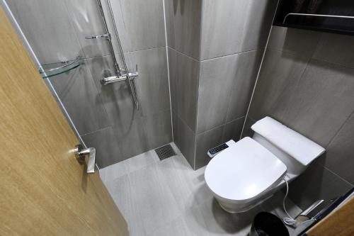 a small bathroom with a toilet and a shower at The Stay Classic Hotel Myeongdong in Seoul