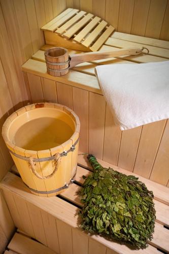 a sauna with a bucket of water and a plant at Alaska Resort in Tsaghkadzor
