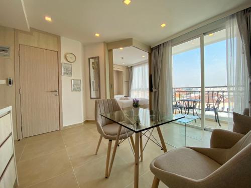 a living room with a glass table and chairs at Olympus city garden by jack in Pattaya South
