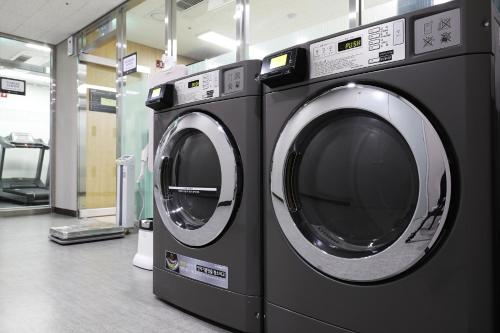 two washing machines sitting next to each other in a store at The Stay Classic Hotel Myeongdong in Seoul
