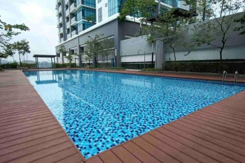a swimming pool in front of a building at Pacific Tower PJ Section 13 WifiParkingOppJayaOne Mall in Petaling Jaya
