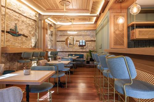 a restaurant with blue chairs and tables at Αρχοντικό Κίτσου - BOUTIQUE HOTEL in Kastoria