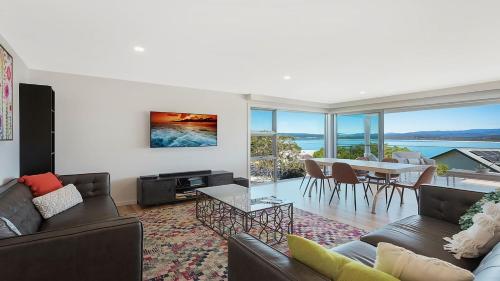a living room with a couch and a table at Unit 2 10 Cliff Street Merimbula in Merimbula