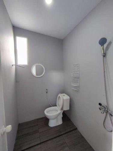 Kembang Homestay Yogyakarta في Seturan: حمام أبيض مع مرحاض في الغرفة
