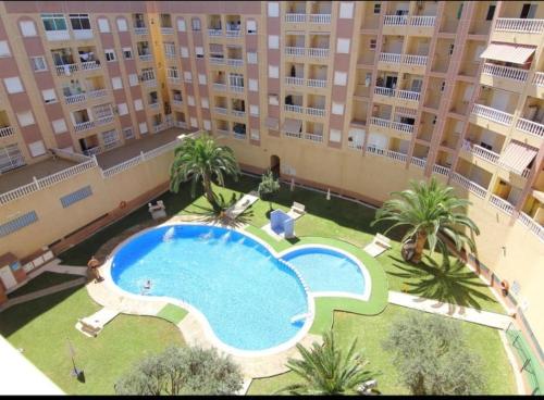 an overhead view of a swimming pool in a building at nice apartment near the park in Torrevieja