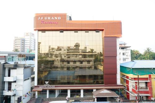 a large building with a reflection of a building at Hotel Signature Cochin in Cochin