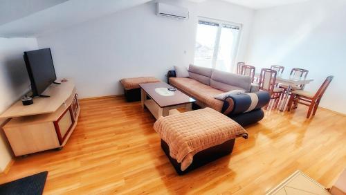 a living room with a couch and a table at The Sunshine apartment in Prilep
