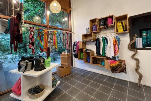 a clothing store with racks of clothes on the wall at Metita Beach & Dive Resort in Doruba
