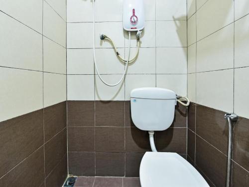a bathroom with a toilet and a shower at Capital O 90761 D Jiwa Hotel in Pendang