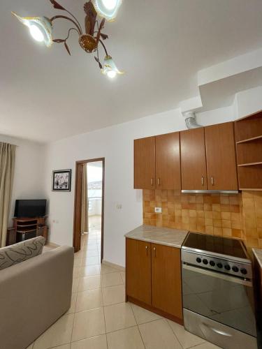 una cucina con mobili in legno e piano cottura con forno di Seaview studio a Sarandë
