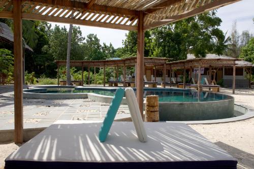 a slide in front of a swimming pool at Metita Beach & Dive Resort in Doruba