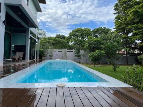 a swimming pool in the backyard of a house at AP HOUSE in Bangkok