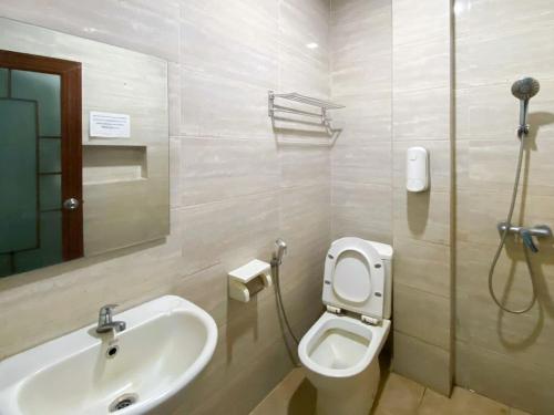 a bathroom with a sink and a toilet at Sentosa Jaya Guest House near RS Hermina Medan RedPartner in Medan