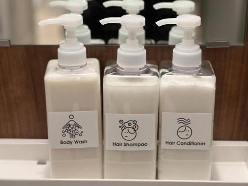a group of three bottles of detergent sitting on a sink at 自由自在OSU 402(KUMO) in Nagoya