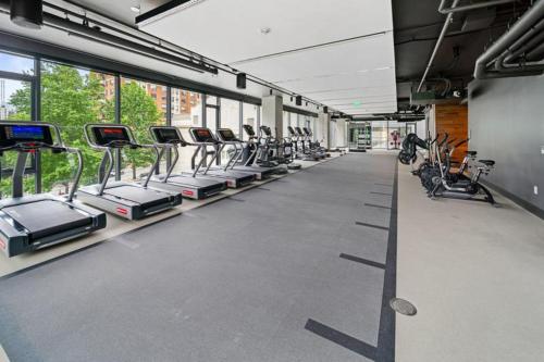 a gym with rows of treadmills and machines at First Hill 2BR w Gym Coworking SEA-461 in Seattle