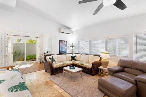 a living room with a couch and a table at Stylish 1BR Apartment with AC Full Kitchen & WD - Just Steps to the Beach in Kailua