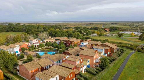 an aerial view of a residential suburb with a pool at Madame Vacances Les Rives Marines in Le Teich