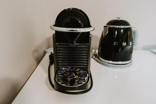 a toaster sitting on a counter next to a tea pot at The Wood Owl Nature's Valley in Natureʼs Valley