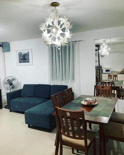 a living room with a blue couch and a table at salty dog homestay in Batangas City